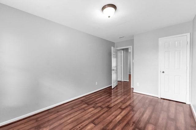 unfurnished bedroom featuring dark wood-type flooring