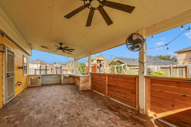 view of patio featuring ceiling fan and a playground