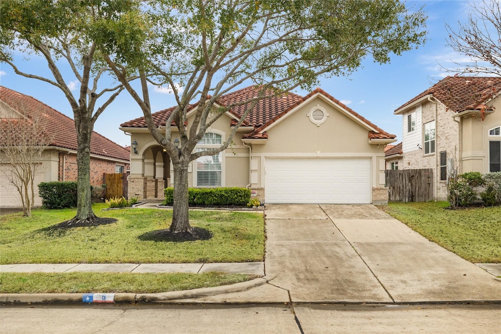 view of front of property with a garage and a front yard