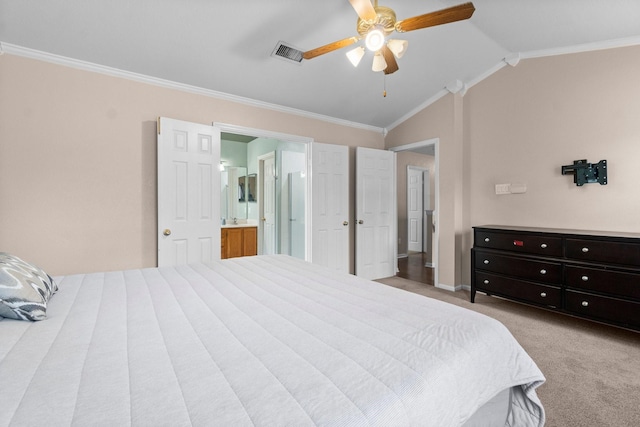 bedroom with crown molding, ensuite bath, ceiling fan, and vaulted ceiling