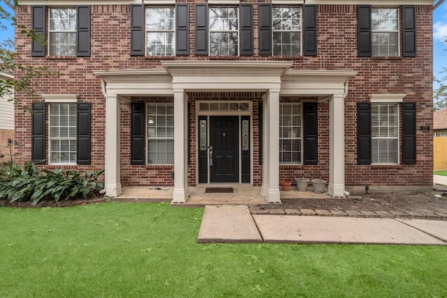 doorway to property with a yard