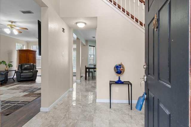 entrance foyer with ceiling fan