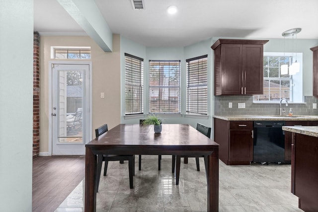 dining room with a healthy amount of sunlight, light hardwood / wood-style floors, and sink