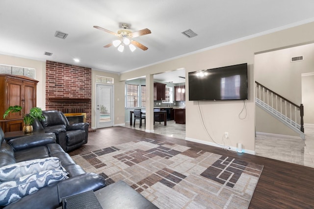 unfurnished living room with dark hardwood / wood-style flooring, a fireplace, ornamental molding, and ceiling fan