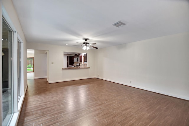 unfurnished living room featuring ceiling fan