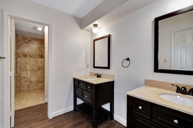 bathroom featuring a tile shower and vanity