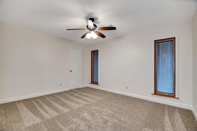 spare room with ceiling fan and carpet