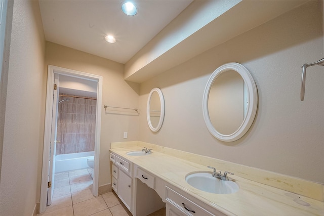 full bathroom featuring vanity, tiled shower / bath, tile patterned floors, and toilet