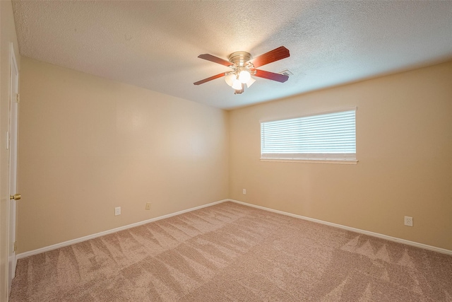 carpeted spare room with ceiling fan and a textured ceiling