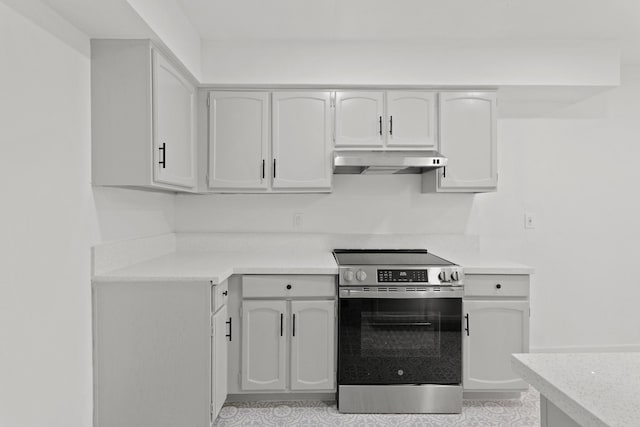 kitchen with stainless steel range with electric stovetop and white cabinets