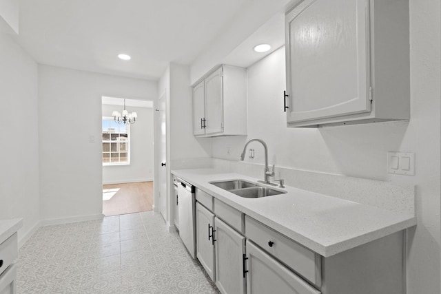 kitchen featuring sink, white cabinetry, light tile patterned floors, stainless steel dishwasher, and a notable chandelier