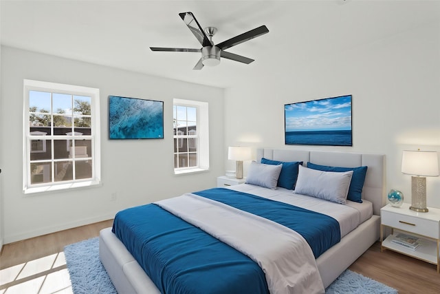 bedroom with ceiling fan and light hardwood / wood-style floors