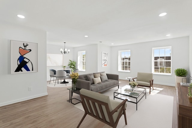 living room featuring an inviting chandelier and light hardwood / wood-style flooring