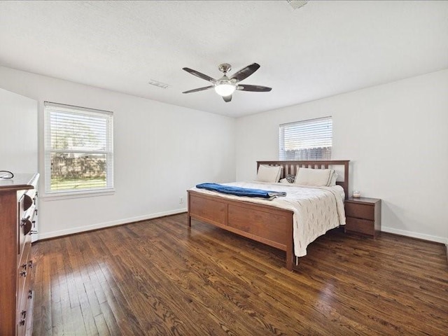 bedroom with ceiling fan and dark hardwood / wood-style floors