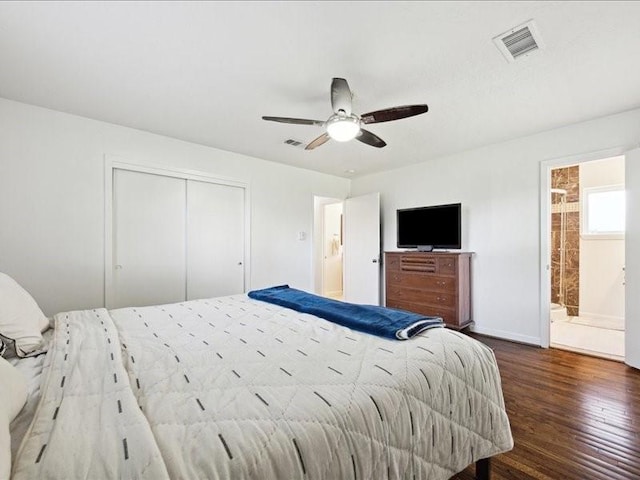 bedroom featuring ensuite bathroom, dark hardwood / wood-style floors, ceiling fan, and a closet