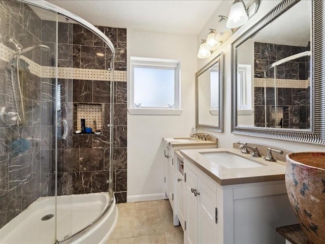 bathroom featuring vanity, a shower with door, and tile patterned floors