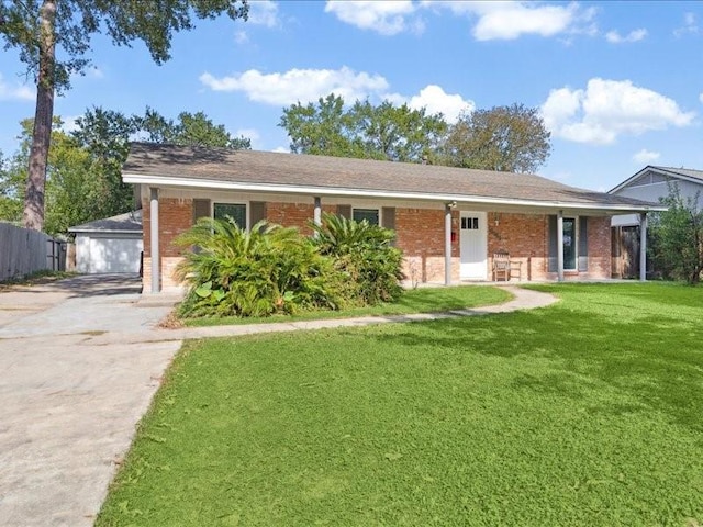 ranch-style house with a garage, an outbuilding, and a front yard