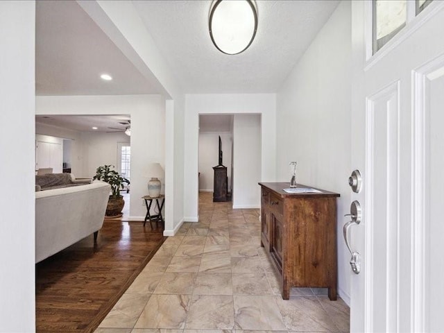 foyer entrance with sink, ceiling fan, and light wood-type flooring