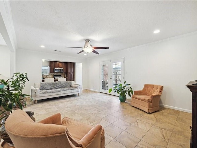 living room with french doors, ceiling fan, ornamental molding, and a textured ceiling