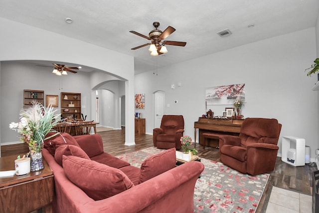 tiled living room with ceiling fan