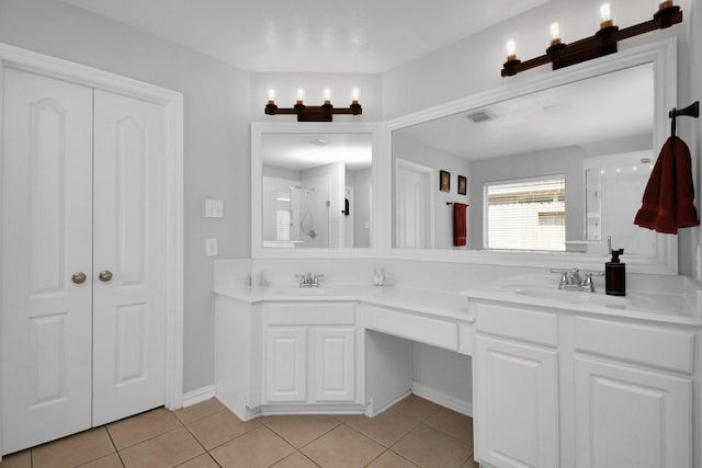 bathroom featuring vanity, tile patterned floors, and walk in shower