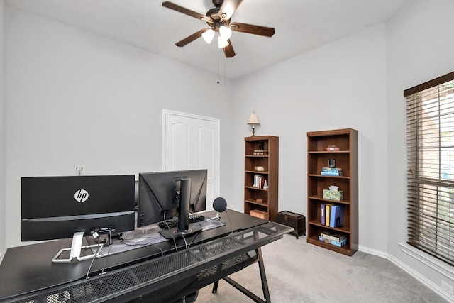 carpeted office space with ceiling fan