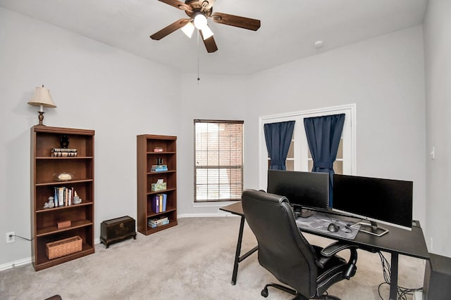 carpeted home office with ceiling fan