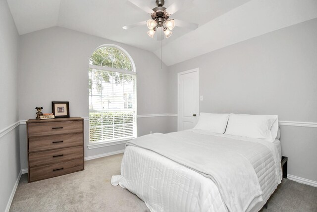 bedroom featuring lofted ceiling, light carpet, and ceiling fan