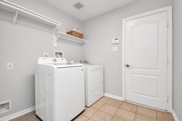 washroom with light tile patterned floors and independent washer and dryer