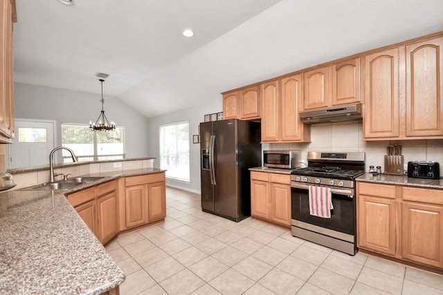 kitchen featuring pendant lighting, sink, appliances with stainless steel finishes, light tile patterned flooring, and vaulted ceiling