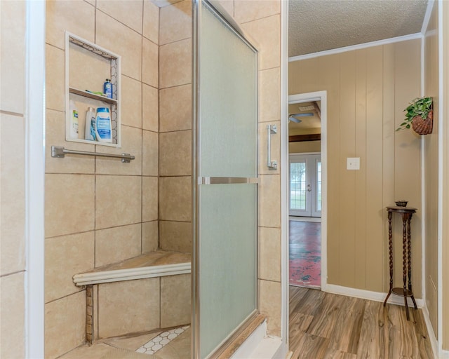 bathroom with crown molding, hardwood / wood-style floors, and a textured ceiling