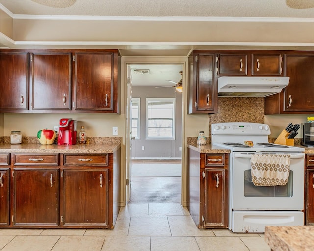 kitchen featuring crown molding, light tile patterned floors, and electric range