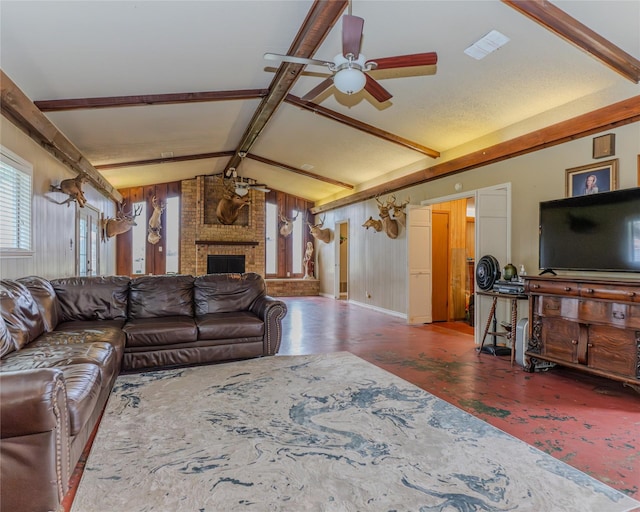 living room featuring lofted ceiling with beams, ceiling fan, and a fireplace