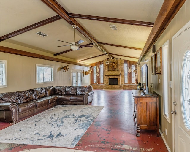 living room featuring ceiling fan, vaulted ceiling with beams, a fireplace, and french doors