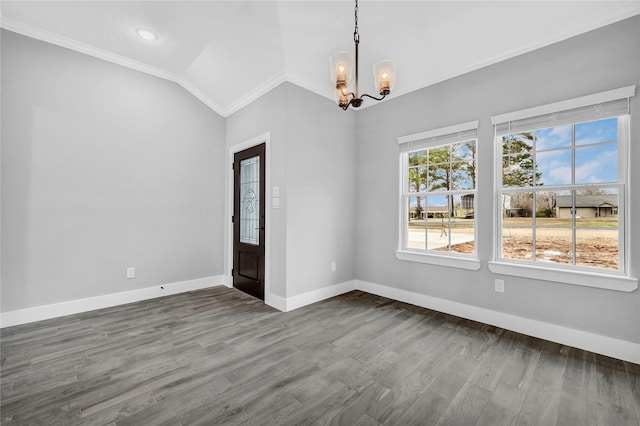 unfurnished room with vaulted ceiling, crown molding, hardwood / wood-style floors, and a chandelier