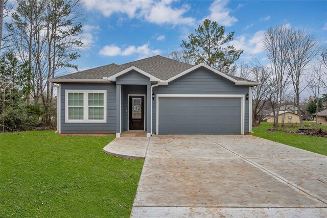 view of front of home with a garage, a front yard, roof with shingles, and driveway