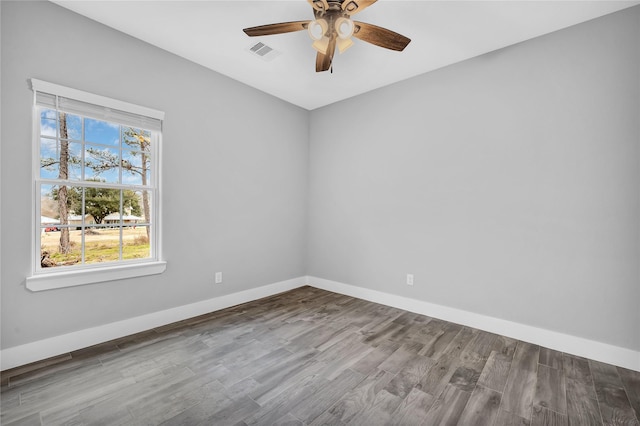 empty room with ceiling fan and light wood-type flooring