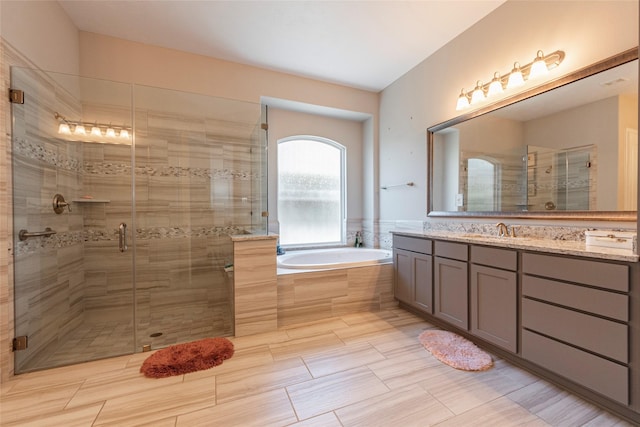 bathroom with vanity and separate shower and tub