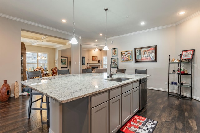 kitchen featuring coffered ceiling, a kitchen island with sink, sink, and gray cabinetry