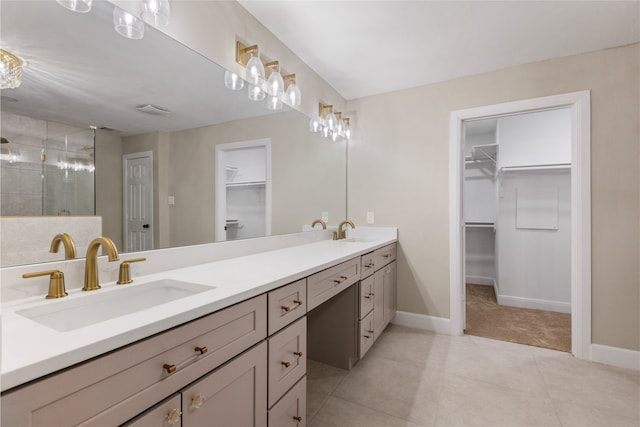 bathroom with tile patterned flooring, vanity, and a shower with shower door