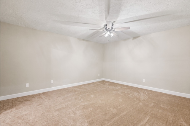 empty room with ceiling fan, a textured ceiling, and carpet