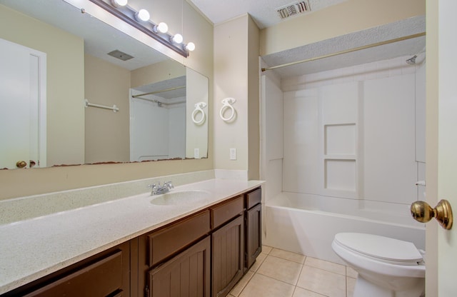 full bathroom with vanity, tile patterned floors, toilet, and washtub / shower combination