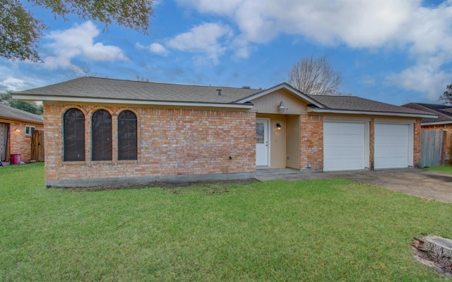 single story home with a garage and a front lawn