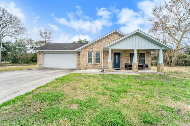 craftsman-style house featuring a garage, covered porch, and a front yard