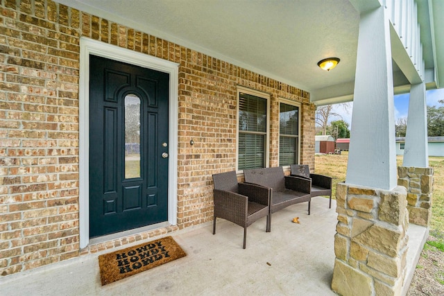 view of exterior entry featuring a porch