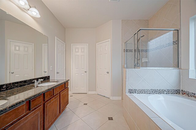 bathroom featuring tile patterned flooring, plus walk in shower, and vanity