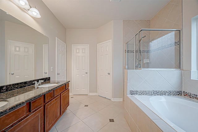 bathroom with double vanity, a bath, tile patterned flooring, a shower stall, and a sink