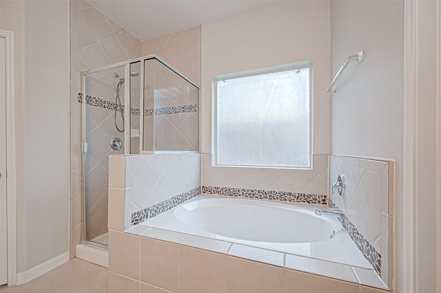 bathroom featuring tile patterned floors and separate shower and tub