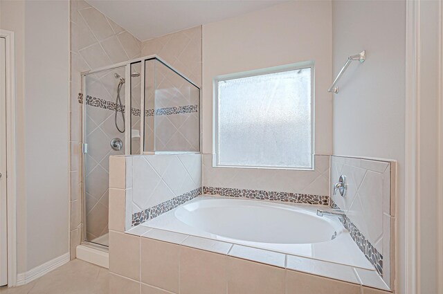 full bath with a garden tub, a shower stall, and tile patterned flooring