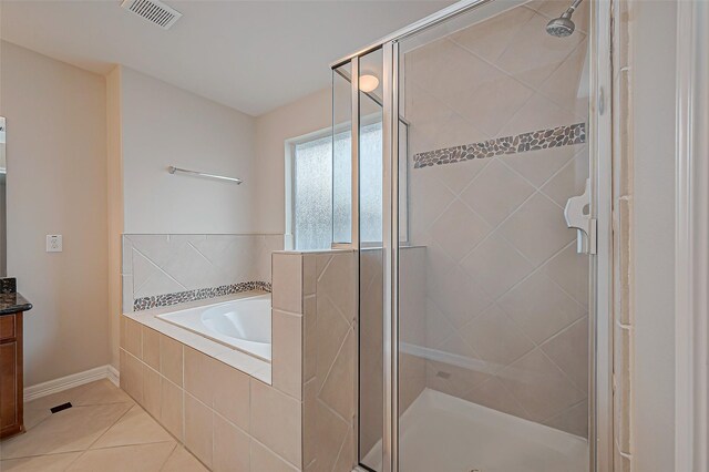 bathroom featuring vanity, independent shower and bath, and tile patterned flooring